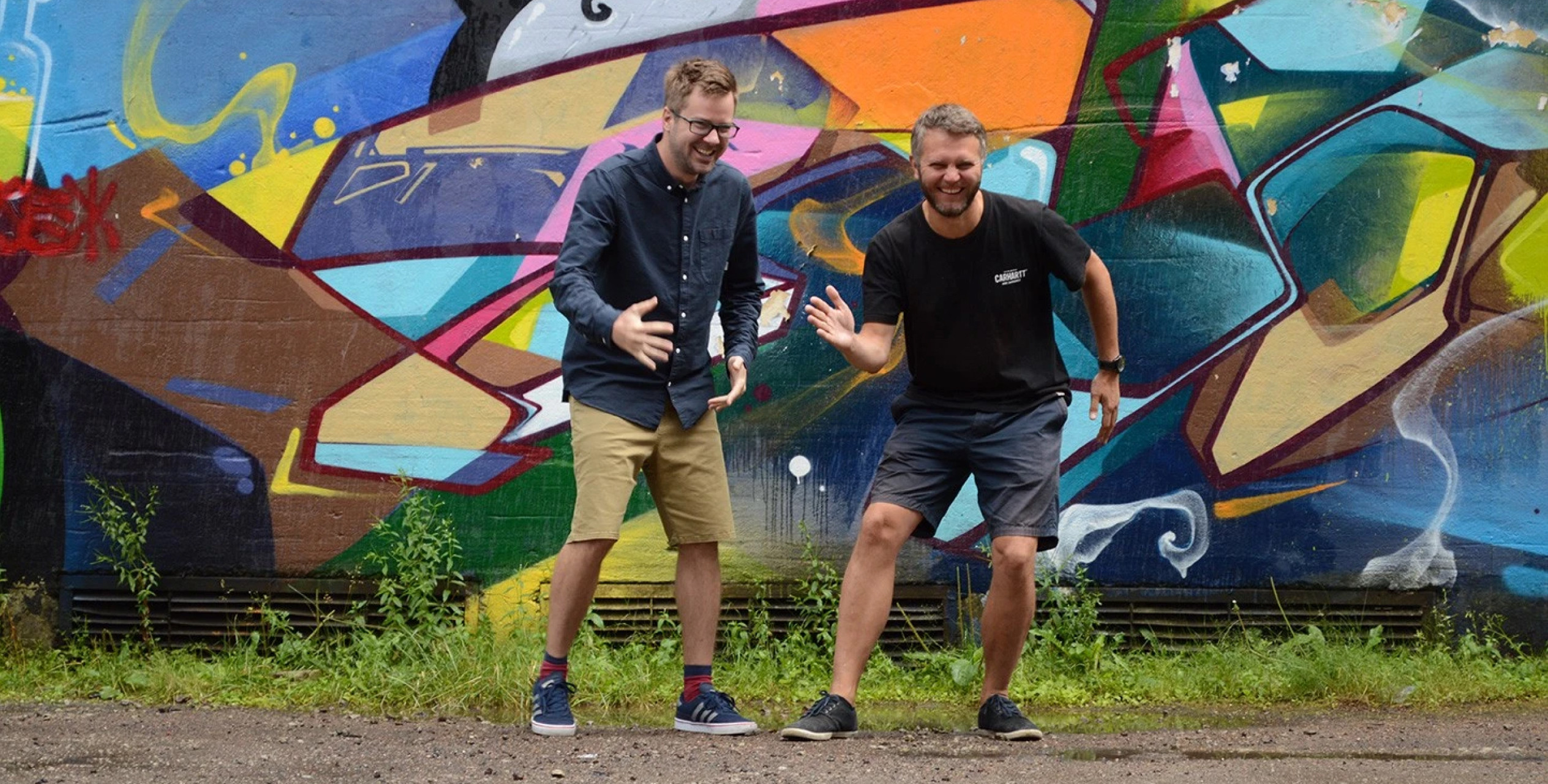 Kevin and Kristian from DUX near a graffiti wall